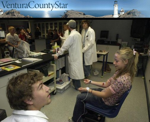 Photos by Jason Redmond / Star staff 
 California Lutheran University science major Thomas Estus, left, watches a projection of student Carson Cute's heart rate graph during a visit to Sycamore Canyon School in Newbury Park on Monday.